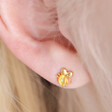Close up of model wearing Orange Opal Bee Stud Earrings in Gold