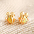 Orange Opal Bee Stud Earrings in Gold on beige coloured fabric