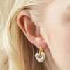 Close Up of Pearl Resin Heart Huggie Hoop Earrings in Gold on Model
