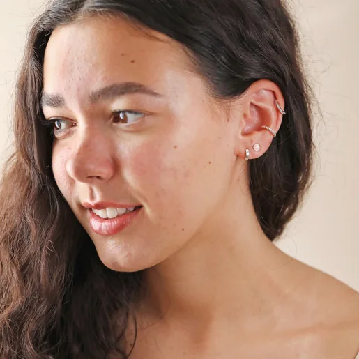 Model Looking to Side Wearing Curated Ear with Pink Opal Flower Stud Earrings in Silver