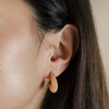 Close Up of Pink Organic Resin Hoop Earrings in Gold on Model
