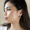 Model Looking to the Side Wearing Pink Organic Resin Hoop Earrings in Gold