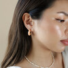 Model Looking Down Wearing Pink Organic Resin Hoop Earrings in Gold
