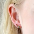 Close Up of Model Wearing Triple Crystal Stud Earrings in Gold