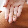 Model Holding Triple Crystal Stud Earrings in Gold