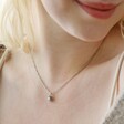 Close Up of Model Wearing Opal and Enamel Floral Pendant Necklace in Silver