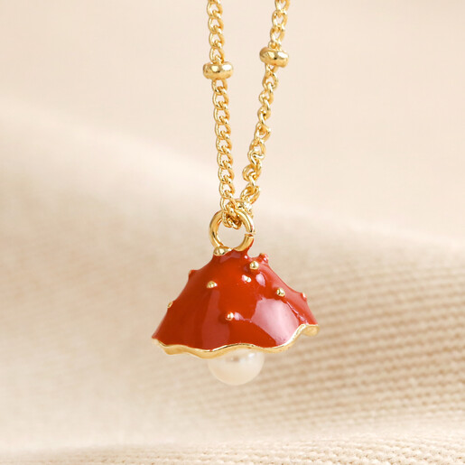 Close Up of toadstool charm on Pearl and Enamel Toadstool Charm Bracelet in Gold