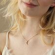 Model Smiling Wearing Sleeping Moon Pendant Necklace in Gold