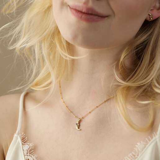 Model Smiling Wearing Sleeping Moon Pendant Necklace in Gold