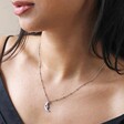 Close Up of Model Wearing Sleeping Moon Pendant Necklace in Silver