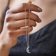 Model Holding Sleeping Moon Pendant Necklace in Silver