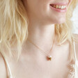 Blonde model wearing Smiley Coffee Cup Pendant Necklace in Gold with light pink top
