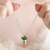 Model holding up Smiley Planter Pendant Necklace in Gold