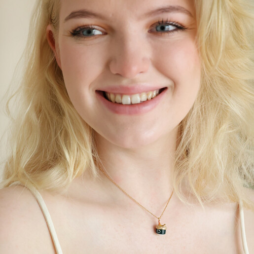 Blonde model wearing Smiley Sushi Pendant Necklace in Gold with pale strap top