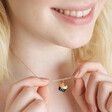Smiling model wearing Smiley Sushi Pendant Necklace in Gold