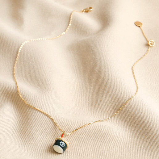 Cute Smiley Sushi Pendant Necklace in Gold on beige fabric