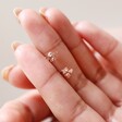 Model Holding Tiny Bee Stud Earrings in Rose Gold
