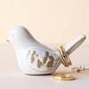 Ceramic Bird Ring Holder With Gold Rings Stacked on Tail