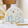 Cornflower Blue Floral Ceramic Earring Holder With Gold Jewellery on Marble Surface