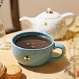 Mug From Cornflower Blue Floral Ceramic Teapot and Mug Set Filled With Tea