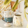 Cornflower Blue Floral Jar Open with Teapot and Mug Set Behind