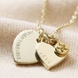 Close Up of Gold Pendant on Personalised Double Heart and Birthstone Charm Necklace on Beige Material