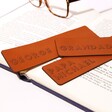 Several Personalised Name Leather Bookmark Resting Inside Pages of Book