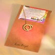 Gold hand-stamped Personalised Rainbow Pride Eternity Pendant Necklace on jewellery card