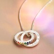 Silver hand-stamped Personalised Rainbow Pride Eternity Pendant Necklace on fabric
