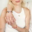 Blonde model wearing Rainbow Pride Eternity Pendant Necklace in Gold with arm around shoulders