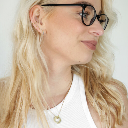 Blonde model in black glasses wearing Rainbow Pride Eternity Pendant Necklace in Gold