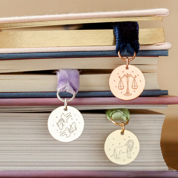 Zodiac Charm Ribbon Bookmark coming out of books 