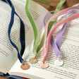 Zodiac Charm Ribbon Bookmarks Laid Out Inside Open Book