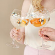 Models Holding Floral Bumblebee Gin Glass Full of Gin Drinks