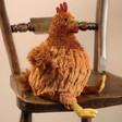 Jellycat Cecile Chicken Soft Toy on Wooden Chair