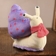 Jellycat Escarfgot Purple Soft Toy Sat on Wooden Chair