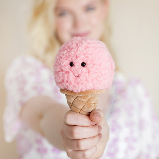Model holding Jellycat Irresistible Ice Cream Strawberry Soft Toy in front 
