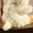 Back of Jellycat Yummy Duckling Soft Toy on Wooden Chair
