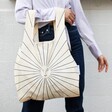 Close up of model holding Kind Bag Sunbeam Reusable Shopping Bag