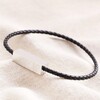 Men's Thin Woven Leather Bracelet in Black on neutral coloured fabric