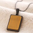 Men's Stainless Steel Tiger's Eye Pendant Necklace close up on beige fabric 