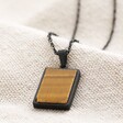 Men's Stainless Steel Tiger's Eye Pendant Necklace on beige background