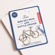 Stainless Steel Bike Keyring and Bottle Opener on top of neutral surface