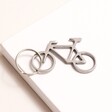 Stainless Steel Bike Keyring and Bottle Opener out of packaging on neutral background