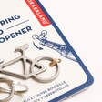 Close up of Stainless Steel Bike Keyring and Bottle Opener in packaging