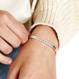 Close Up of Model holding Adjustable 'All Things Lovely' Meaningful Word Wave Bangle in Silver on wrist