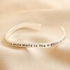 Adjustable Favourite Person Meaningful Word Wave Bangle in Silver on beige material