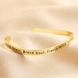 First Side of Adjustable Nana Meaningful Word Wave Bangle in Gold on Beige Fabric
