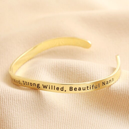 Adjustable Nana Meaningful Word Wave Bangle in Gold Second Side of Adjustable Nana Meaningful Word Wave Bangle in Gold on Beige Fabric