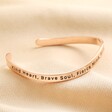 First side of Adjustable Nana Meaningful Word Wave Bangle in Rose Gold on beige background